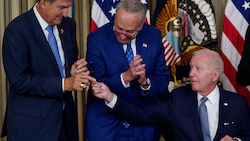 Joe Biden reaching for a pen