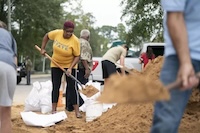 People shoveling sand